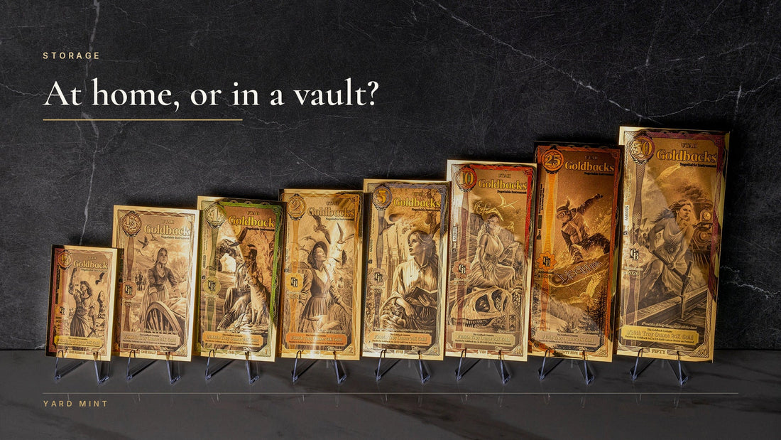 A full ladder of Utah Goldbacks from the quarter to the 50 standing on display stands against dark marble, beneath the words At home, or in a vault?
