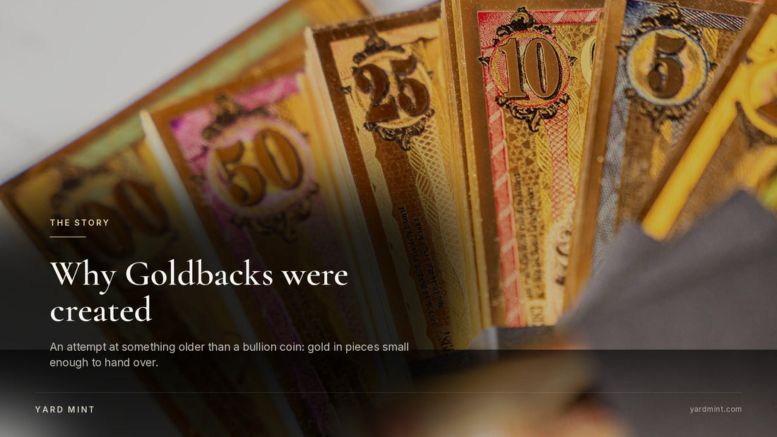 Photograph of a fan of Oklahoma Goldbacks showing the 100, 50, 25, 10 and 5 denominations held in a hand